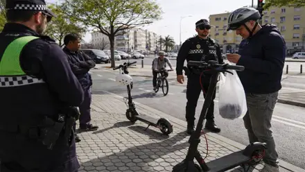 Policías multando a usuarios de patinetes eléctricos.