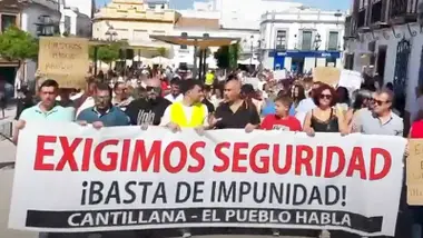 Protesta de los vecinos que portan una pancarta contra la inseguridad en Cantillana.